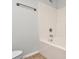 Bathroom showcasing a white tiled shower/tub with neutral walls at 1125 Kurt Ct, Charlotte, NC 28209