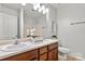 Bathroom featuring a double sink vanity, a large mirror, and neutral paint at 1125 Kurt Ct, Charlotte, NC 28209