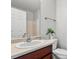 A bathroom featuring a wood vanity, white sink, toilet and shower at 1125 Kurt Ct, Charlotte, NC 28209