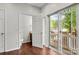 Bedroom with door to an en-suite bathroom and sliding glass doors to a private balcony at 1125 Kurt Ct, Charlotte, NC 28209