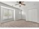 A bedroom featuring neutral carpet, a ceiling fan, and large windows at 1125 Kurt Ct, Charlotte, NC 28209