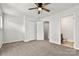 Bedroom featuring neutral walls, ceiling fan, and carpet, with an ensuite bathroom at 1125 Kurt Ct, Charlotte, NC 28209