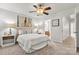 Bedroom with neutral decor, an adjacent bathroom, and a large painting on the wall at 1125 Kurt Ct, Charlotte, NC 28209