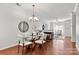 Dining area featuring hardwood floors, modern lighting, and open to the living room at 1125 Kurt Ct, Charlotte, NC 28209
