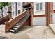 Brick townhome exterior with attached garages and stairs leading to the front door at 1125 Kurt Ct, Charlotte, NC 28209