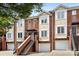 Brick townhome exterior with stairs leading to the front door and attached garages at 1125 Kurt Ct, Charlotte, NC 28209