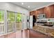 Bright kitchen with granite countertops, stainless steel appliances, and sliding door to outdoor deck at 1125 Kurt Ct, Charlotte, NC 28209