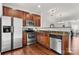 Well-lit kitchen featuring stainless steel appliances, warm wood cabinets and an open layout at 1125 Kurt Ct, Charlotte, NC 28209