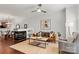 Cozy living room with a fireplace, ceiling fan and a stylish rug over hardwood flooring at 1125 Kurt Ct, Charlotte, NC 28209