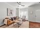 Comfortable living room featuring hardwood floors and a large window with natural light at 1125 Kurt Ct, Charlotte, NC 28209