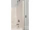 Close-up of a shower with white walls and a chrome shower head and faucet at 1125 Kurt Ct, Charlotte, NC 28209