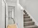 Carpeted stairs leading up to the second floor with access to the garage at 1125 Kurt Ct, Charlotte, NC 28209