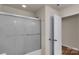 Bathroom featuring a shower-tub combo with a decorative sliding glass door at 11538 Ardrey Crest Dr, Charlotte, NC 28277