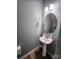 Cozy half bathroom with modern fixtures, pedestal sink and wood look flooring at 11538 Ardrey Crest Dr, Charlotte, NC 28277