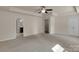 Large bedroom featuring neutral carpeting, ceiling fan, and doors to closets and bathroom at 11538 Ardrey Crest Dr, Charlotte, NC 28277