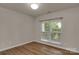 Bedroom featuring LVP flooring and a window overlooking a lush yard at 11538 Ardrey Crest Dr, Charlotte, NC 28277