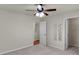 Clean bedroom with ceiling fan; white doors include access to bathroom and closet with wire shelves at 11538 Ardrey Crest Dr, Charlotte, NC 28277