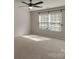 Empty bedroom features a ceiling fan, a window with blinds, and neutral carpet at 11538 Ardrey Crest Dr, Charlotte, NC 28277