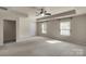 Spacious bedroom with a ceiling fan, tray ceiling, and two windows providing natural light at 11538 Ardrey Crest Dr, Charlotte, NC 28277