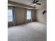 Spacious bedroom with tray ceilings and carpet featuring a ceiling fan at 11538 Ardrey Crest Dr, Charlotte, NC 28277