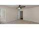 A bedroom with neutral walls, carpet, ceiling fan, and an adjoining walk-in closet at 11538 Ardrey Crest Dr, Charlotte, NC 28277
