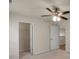 Bright bedroom with ceiling fan, and carpet; features 2 white doors and a closet with wire shelves at 11538 Ardrey Crest Dr, Charlotte, NC 28277