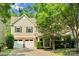 Inviting home featuring a two-car garage, landscaped yard, and classic architectural details at 11538 Ardrey Crest Dr, Charlotte, NC 28277