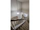 View of a well lit foyer from the top of the carpeted staircase with white railing at 11538 Ardrey Crest Dr, Charlotte, NC 28277