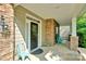 Cozy front porch with stone accents, seating, and a stylish front door at 11538 Ardrey Crest Dr, Charlotte, NC 28277