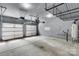 Spacious three car garage with finished walls, water heater, and overhead storage at 11538 Ardrey Crest Dr, Charlotte, NC 28277