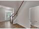 Hallway featuring a staircase, LVP floors, and adjacent powder room at 11538 Ardrey Crest Dr, Charlotte, NC 28277