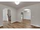 Open hallway featuring arched entryways and luxury vinyl plank flooring at 11538 Ardrey Crest Dr, Charlotte, NC 28277