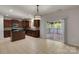 Well-lit kitchen with access to a deck, stainless steel appliances, granite counters and tile floors at 11538 Ardrey Crest Dr, Charlotte, NC 28277
