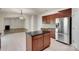 Open kitchen with stainless steel refrigerator, granite counters, kitchen island and view to living room at 11538 Ardrey Crest Dr, Charlotte, NC 28277