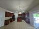 Spacious kitchen features dark cabinets, an island, stainless steel appliances, tile floor and ample counter space at 11538 Ardrey Crest Dr, Charlotte, NC 28277