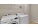 Laundry room featuring modern, white washer and dryer set with overhead shelving at 11538 Ardrey Crest Dr, Charlotte, NC 28277