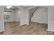 Open-concept living room with elegant archways and luxury vinyl flooring at 11538 Ardrey Crest Dr, Charlotte, NC 28277