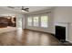 Open living room flows into kitchen and features hardwood floors, fireplace, and three large windows at 11538 Ardrey Crest Dr, Charlotte, NC 28277
