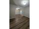 Open-concept room with hardwood floors, arched doorways, and plenty of natural light at 11538 Ardrey Crest Dr, Charlotte, NC 28277