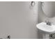 Powder room featuring a pedestal sink with modern fixtures at 11538 Ardrey Crest Dr, Charlotte, NC 28277