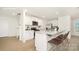 Bright kitchen with white cabinets, granite countertops, stainless steel appliances, and a breakfast bar with seating at 12019 Zazu Way, Charlotte, NC 28215