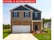 Charming two-story home with a brick facade, attached two car garage and well-maintained lawn at 12020 Zazu Way, Charlotte, NC 28215