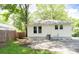 Rear view of house showcasing the yard, air conditioning unit, and paved driveway at 1208 Martin Luther King Ave, Kannapolis, NC 28083