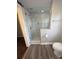 Luxurious tiled shower with glass door, stylish fixtures, and a built-in shelf for toiletries at 1208 Martin Luther King Ave, Kannapolis, NC 28083