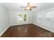 Sun-filled bedroom boasts hardwood floors and crisp white trim, complemented by a ceiling fan at 1208 Martin Luther King Ave, Kannapolis, NC 28083
