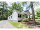Charming home with long driveway and a covered front porch and landscaped front yard, creating an inviting curb appeal at 1208 Martin Luther King Ave, Kannapolis, NC 28083
