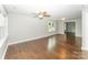 Bright living room featuring beautiful hardwood floors, modern lighting, and a neutral color palette at 1208 Martin Luther King Ave, Kannapolis, NC 28083