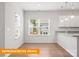 Bright and airy kitchen with large windows, white cabinets, and elegant countertops and stainless sink at 1279 Langston Ln, Salisbury, NC 28144