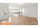 Open-concept living space featuring modern kitchen and sleek hardwood floors at 1279 Langston Ln, Salisbury, NC 28144