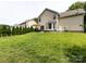 Beautiful backyard featuring a large lawn, patio set, and well-maintained landscaping at 12928 Windy Lea Ln, Huntersville, NC 28078